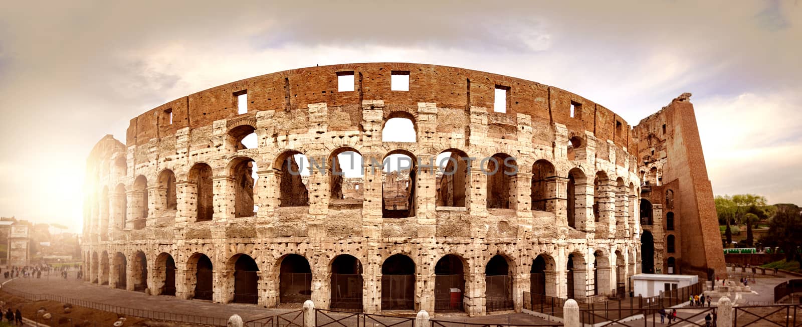 the Colosseum of Rome seen from behind at sunset. Ancient Roman civilization.