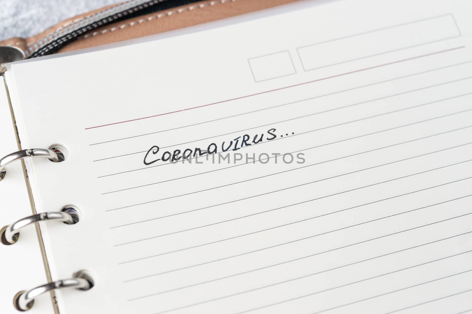 Coronavirus Covid-19 text hand-written on empty sheet in a daily by alexsdriver