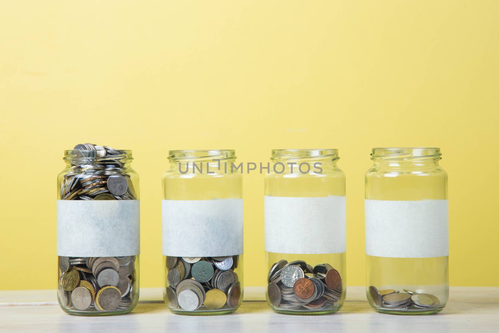An empty label of glass jars with coins. saving concept.