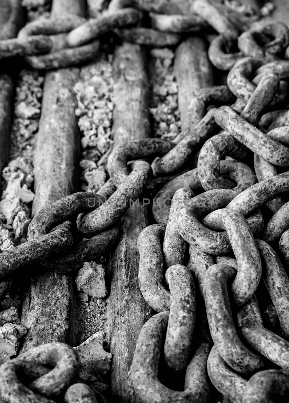 Rusty chain at construction site in black and white