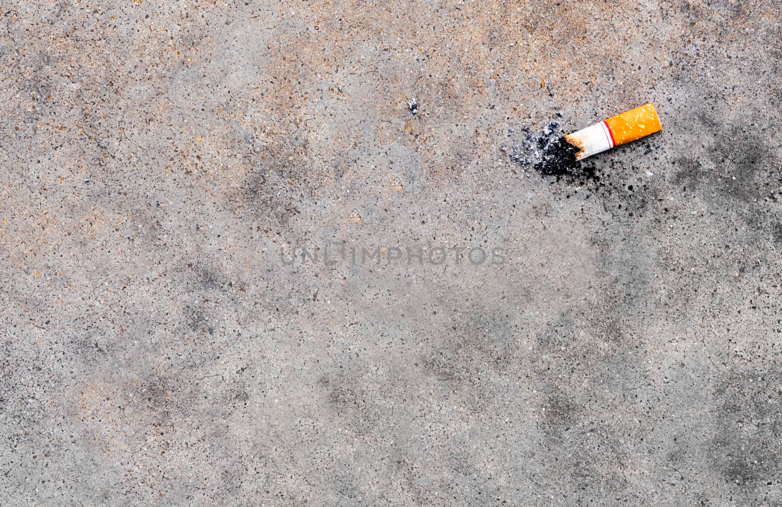 The cigarette butt let down on the concrete floor