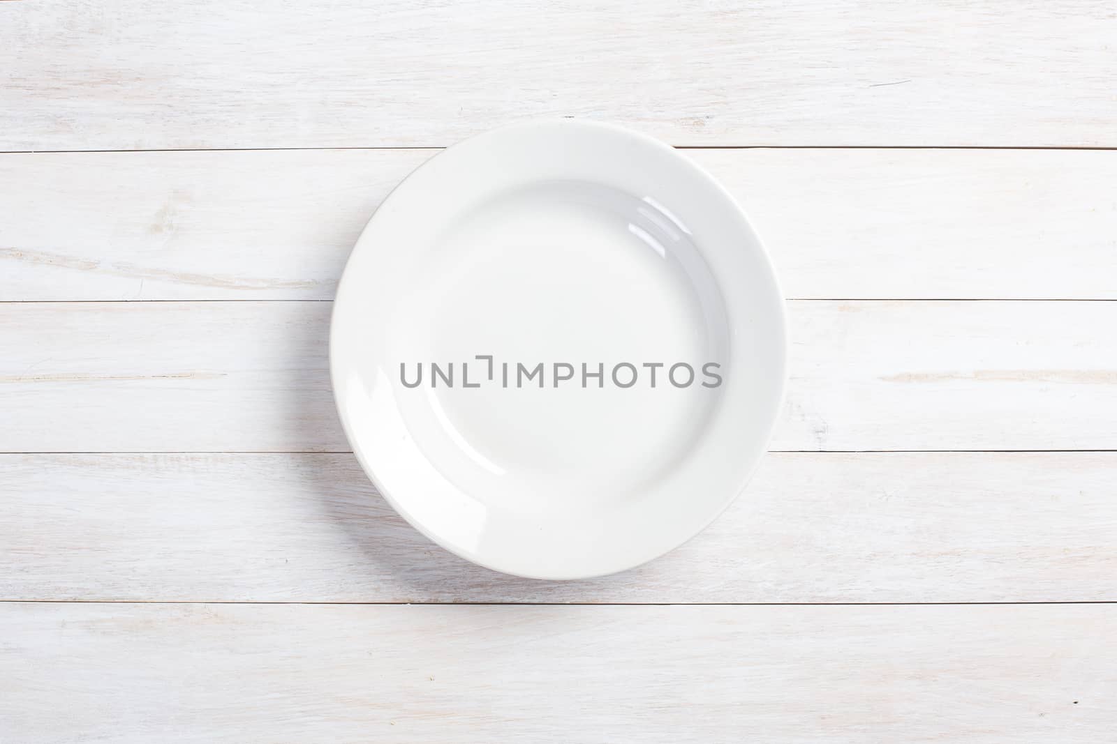  plate on white wooden table by tehcheesiong