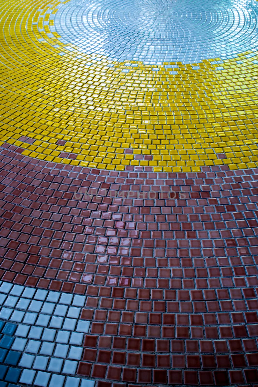 Yellow, White and Brown tiles on the floor of hall