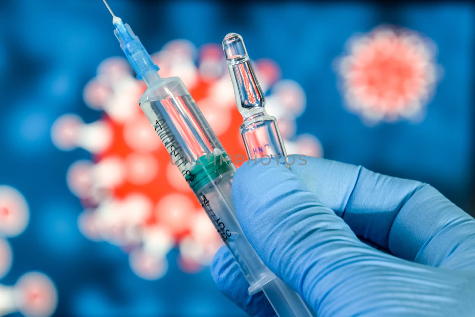 Coronavirus vaccine. A hand in medical gloves holds a vaccine and a syringe against the background of the image of a coronavirus. covid-19,