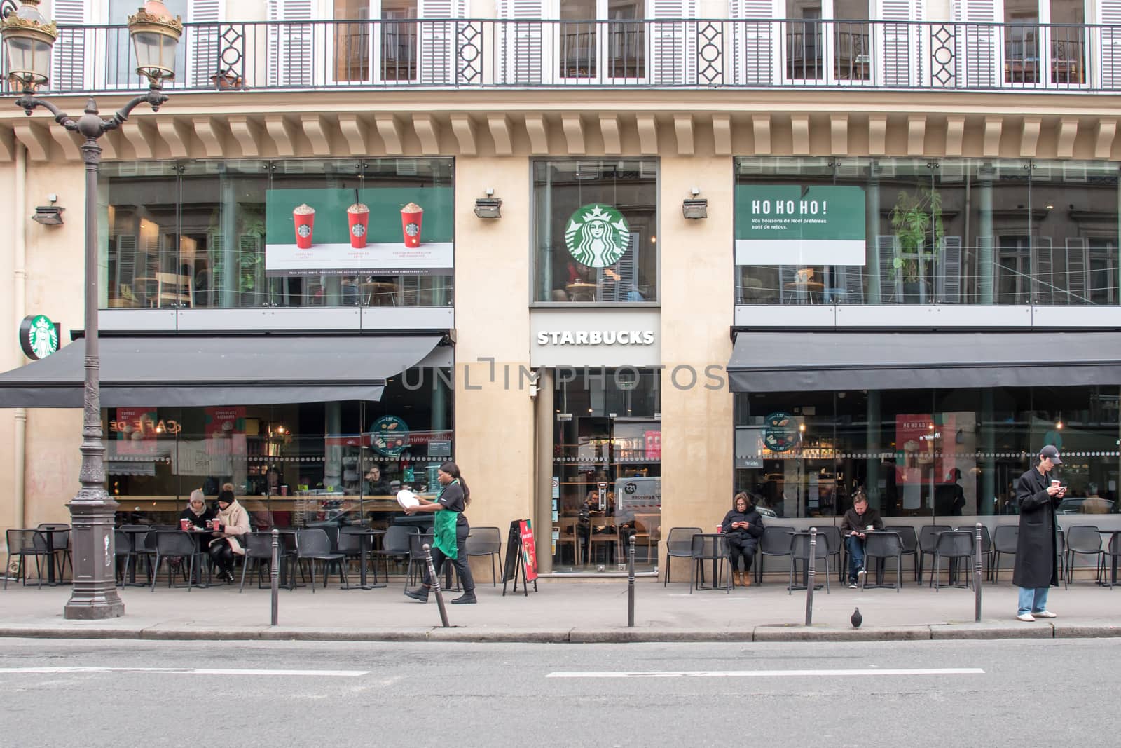 Starbucks Store in Paris, France, international coffee brand shop facade on " Rue saint Honoré " in Paris