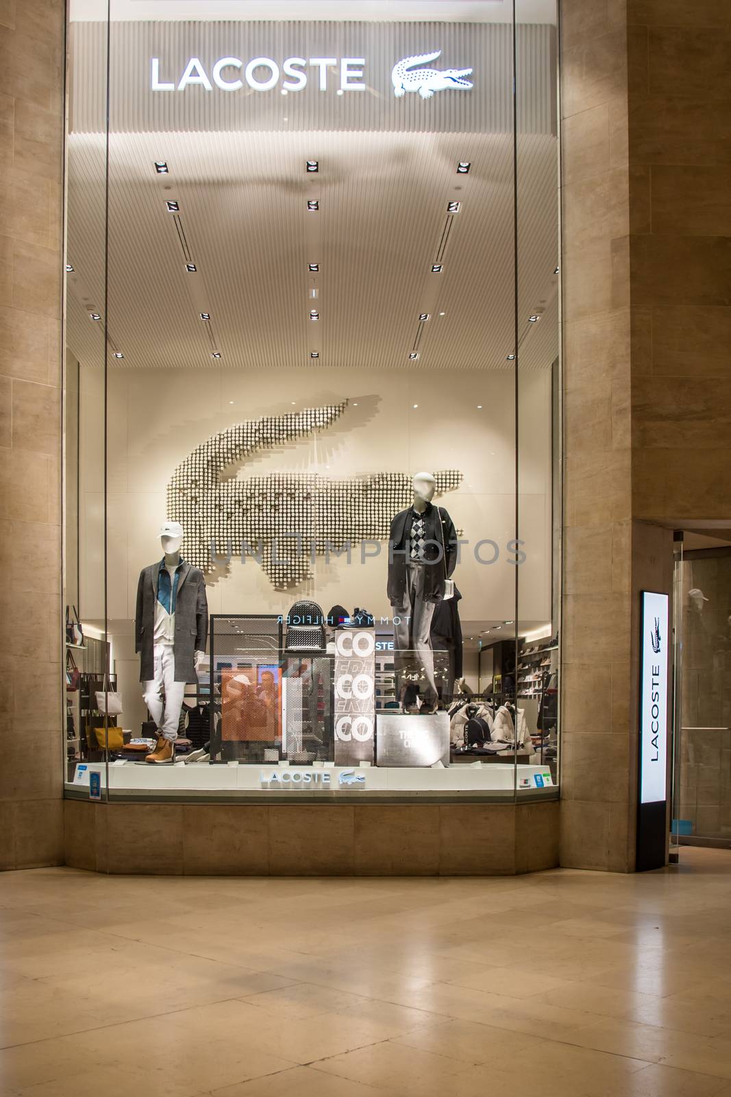 Lacoste Store facade in Paris, France, famous french Luxury clothe brand in Le Louvre Mall