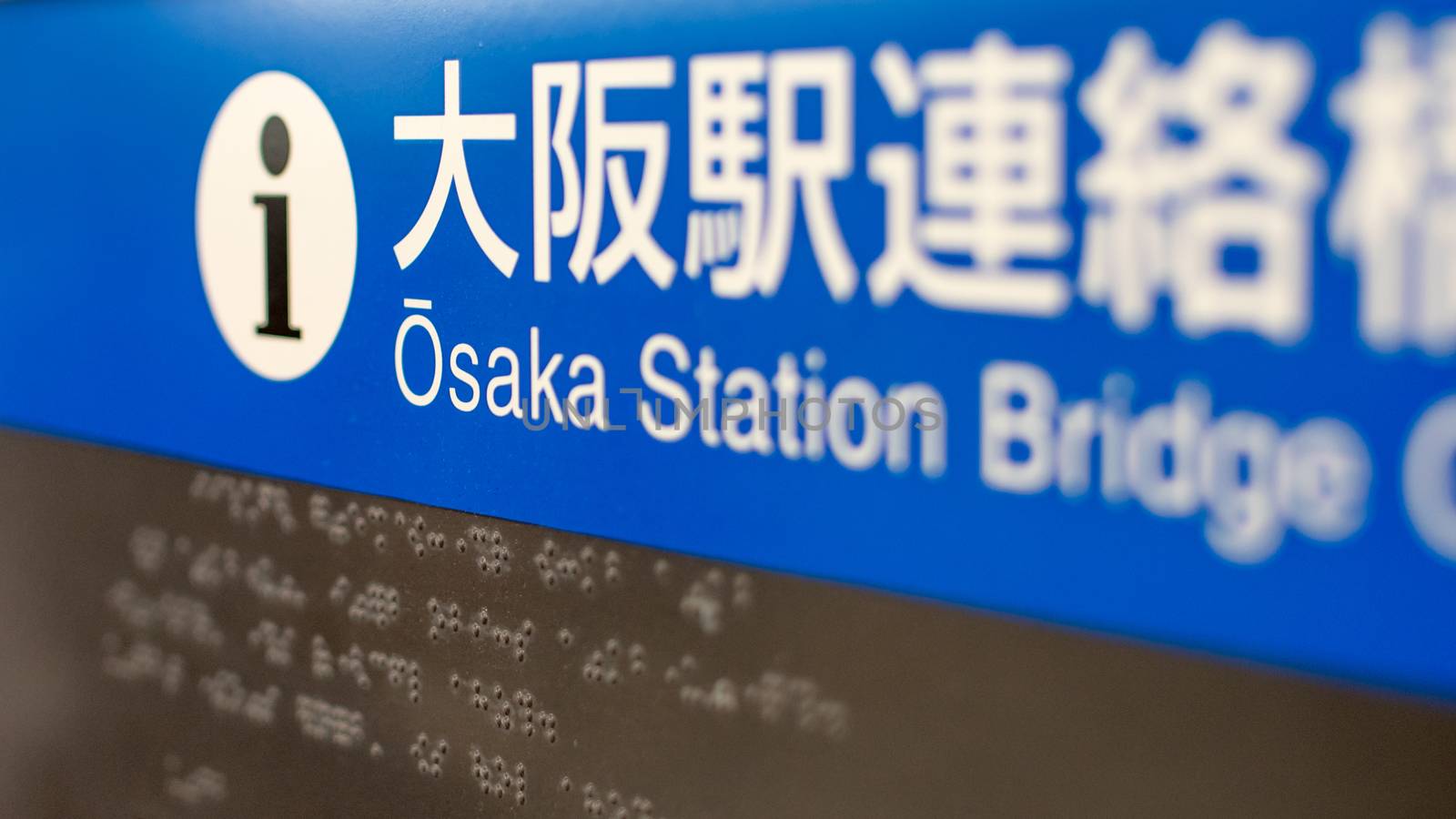 Close shot of Osaka Station Sign, with braille in Background by ontheroadagain