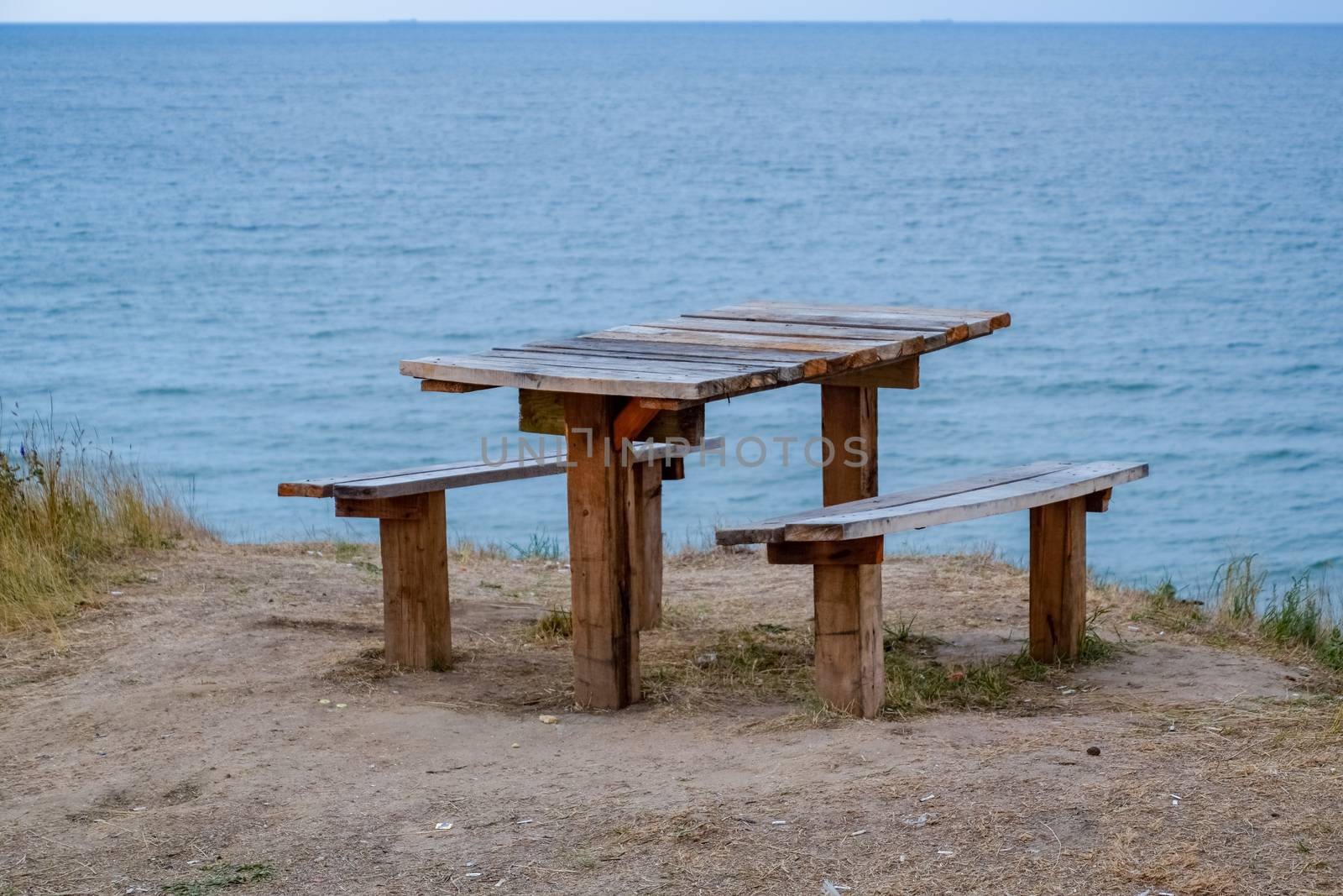 table and benches by the sea. A place to sit and relax. by fedoseevaolga