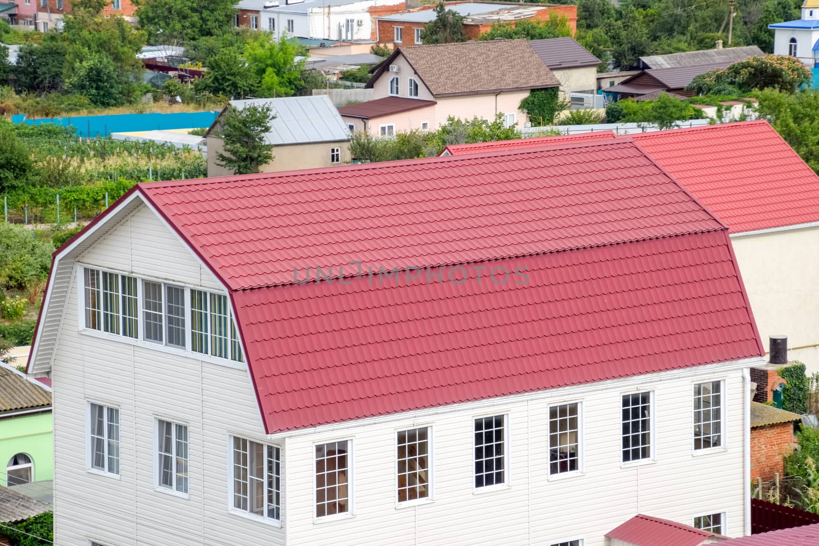 Roof made of metal. Construction with modern roofing materials. Corrugated metal profile.