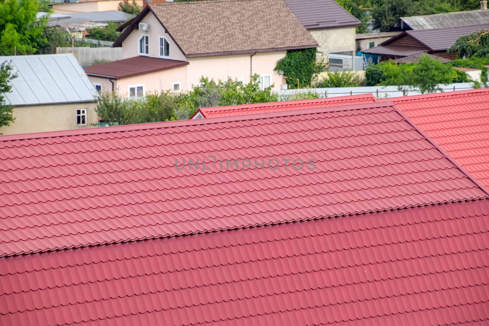 Roof made of metal. Construction with modern roofing materials. Corrugated metal profile.