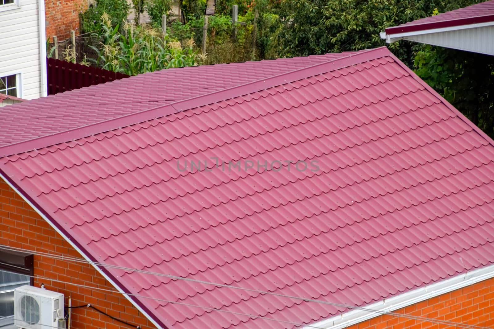 Roof made of metal. Construction with modern roofing materials. Corrugated metal profile.