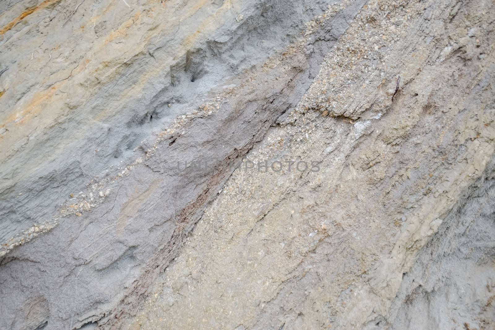 The sedimentary layers of the rock in the sand scree. sand, pebbles and shells in sedimentary rocks.