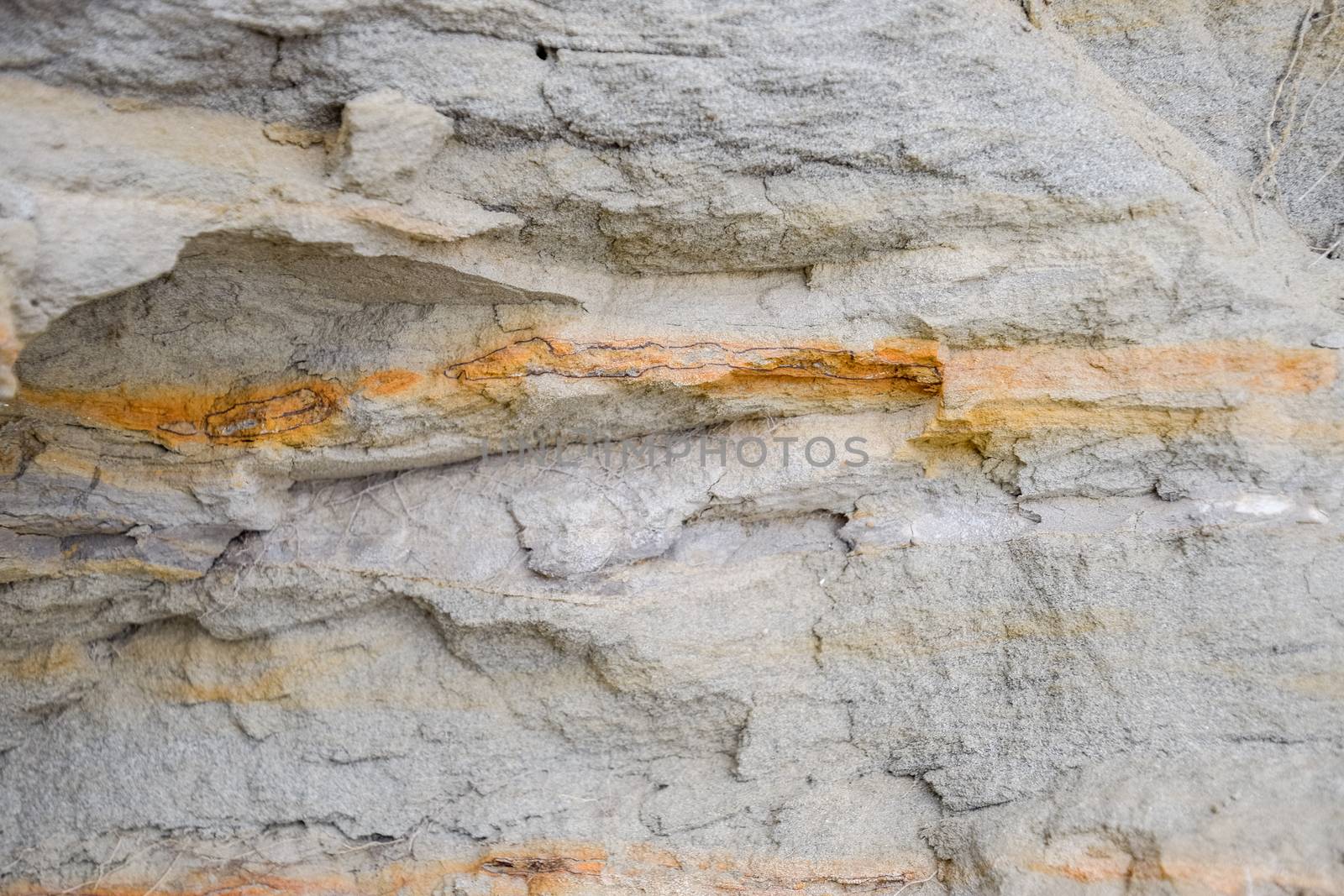 The sedimentary layers of the rock in the sand scree. sand, pebbles and shells in sedimentary rocks.