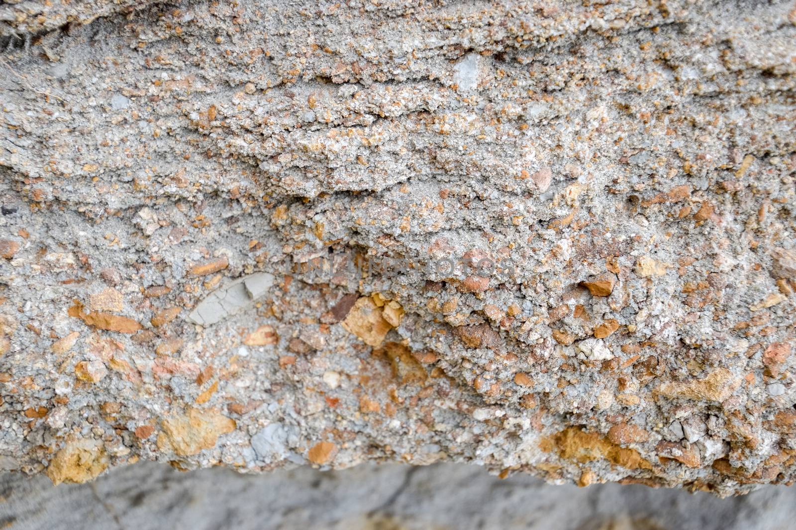 The sedimentary layers of the rock in the sand scree. sand, pebbles and shells in sedimentary rocks.