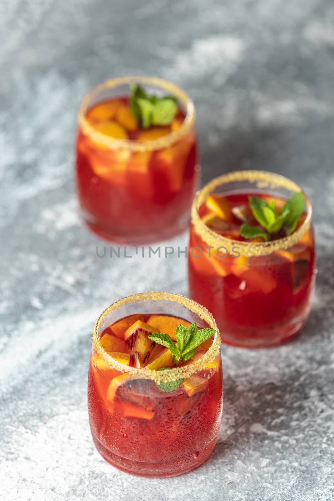 Three glasses of campari gin spritz. Cocktail of sweet, a touch  by ArtSvitlyna