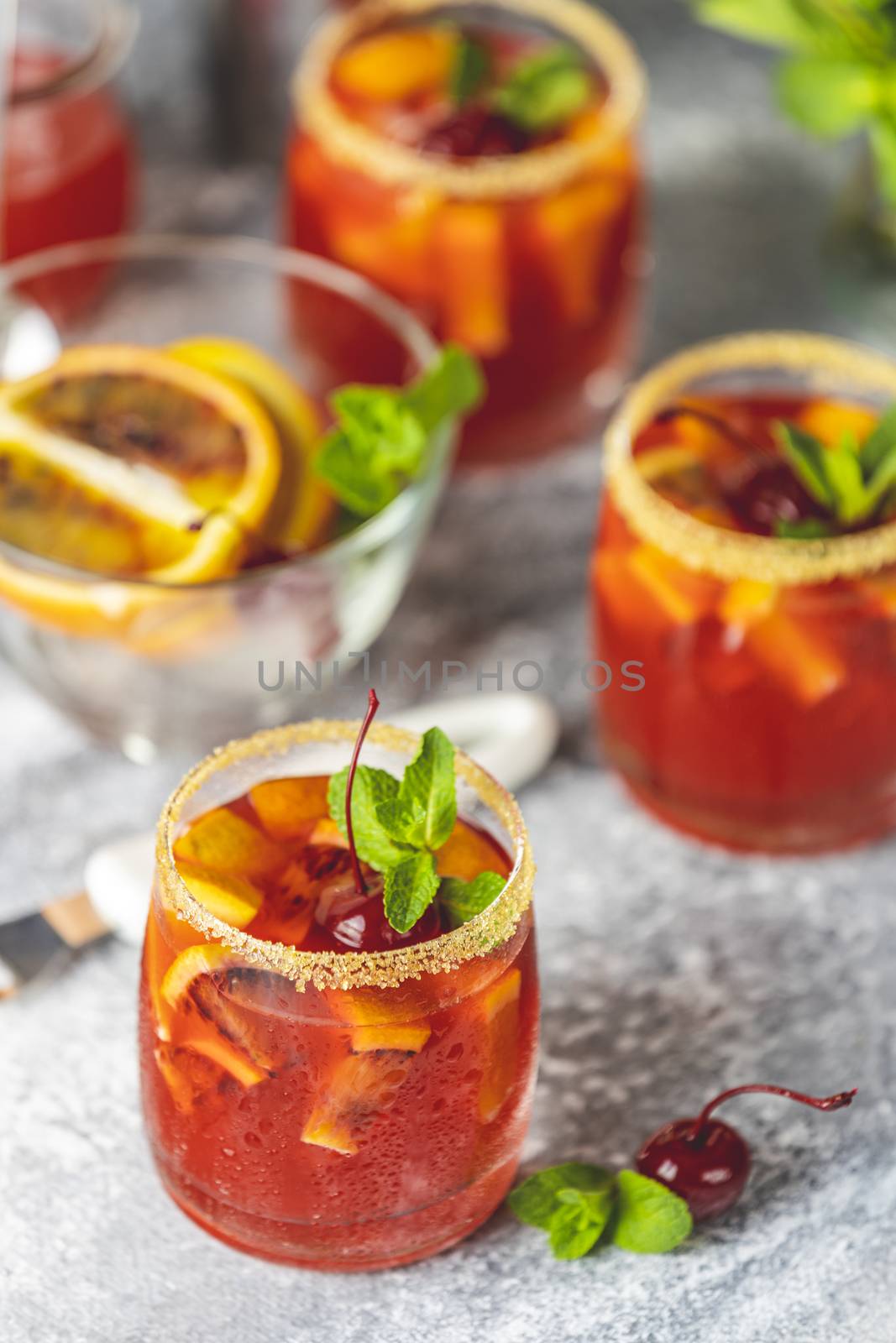 Italian aperol spritz cocktail with orange slices and ingredients on light gray stone table. Summer drink, homemade sangria, Cocktail of sweet. Copy space