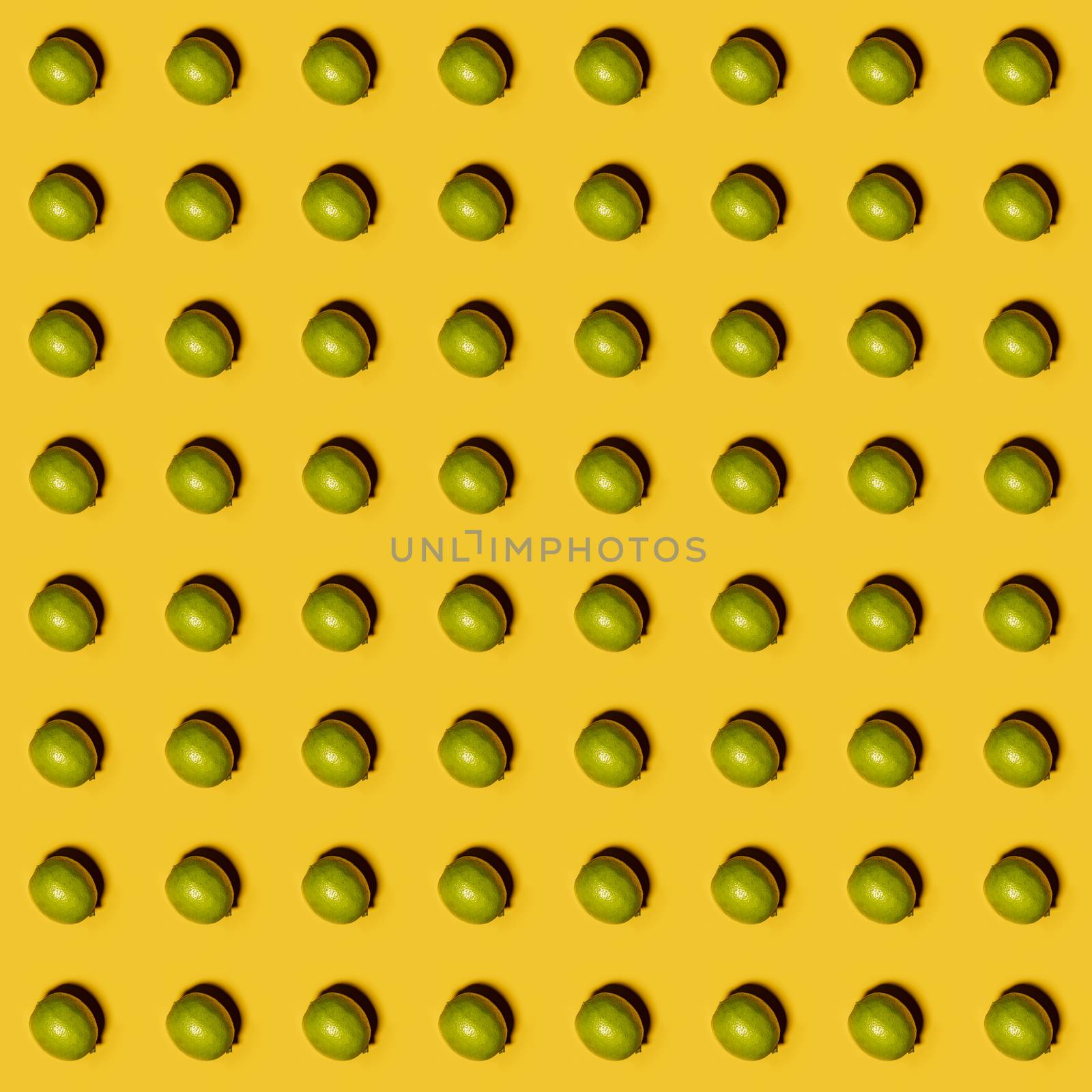 Limes pattern on yellow background. Creative food concept. Flat lay.