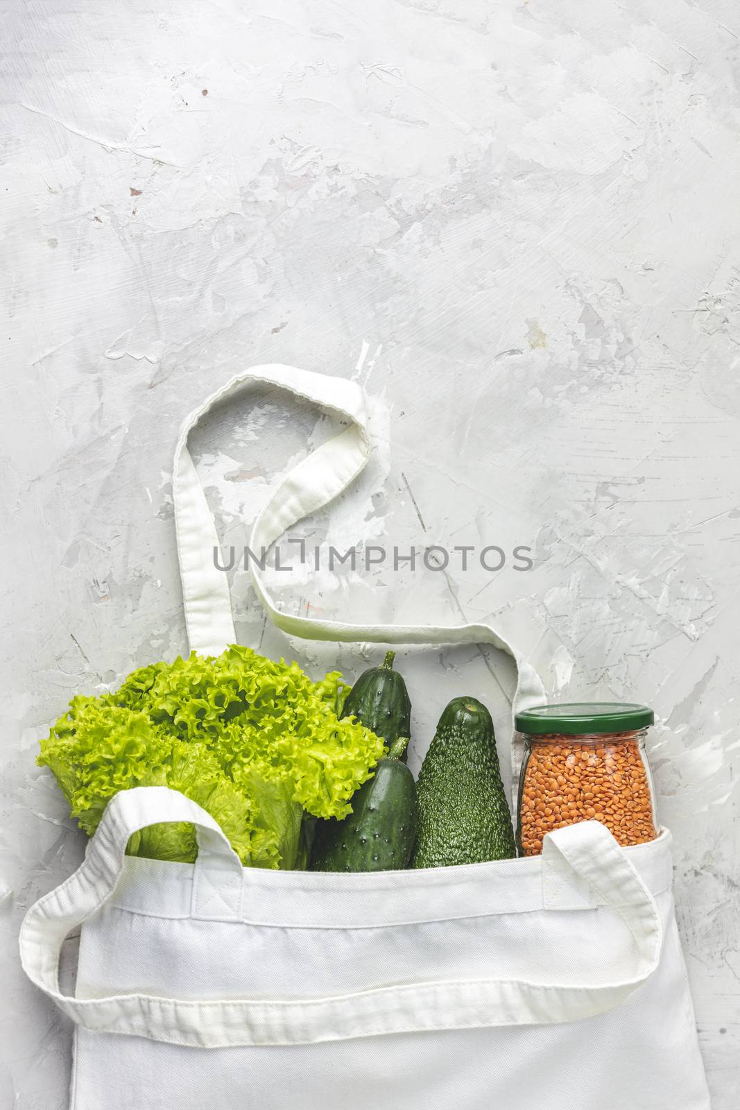 Zero waste concept. Eco-friendly shopping, flat lay. Fresh organic green vegetables and fruits on gray background. Spring diet, healthy raw vegetarian, vegan concept, alkaline clean eating