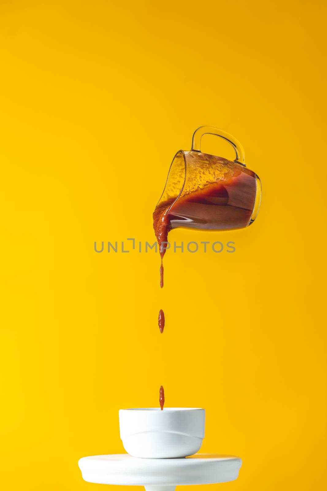 Sauce in glass jar frozen in the air. Pouring homemade DIY natur by ArtSvitlyna