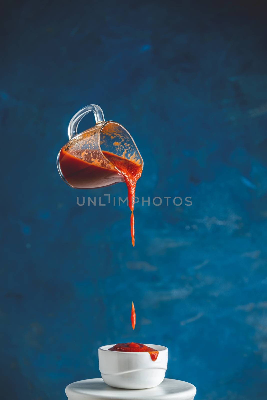 Sauce in glass jar frozen in the air. Pouring homemade DIY natur by ArtSvitlyna