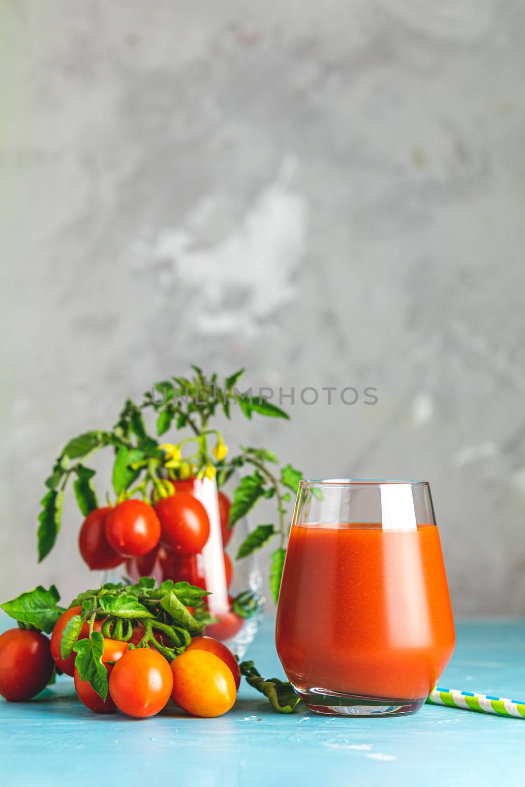 Glasses of fresh delicious jummy red tomato juice and fresh raw  by ArtSvitlyna