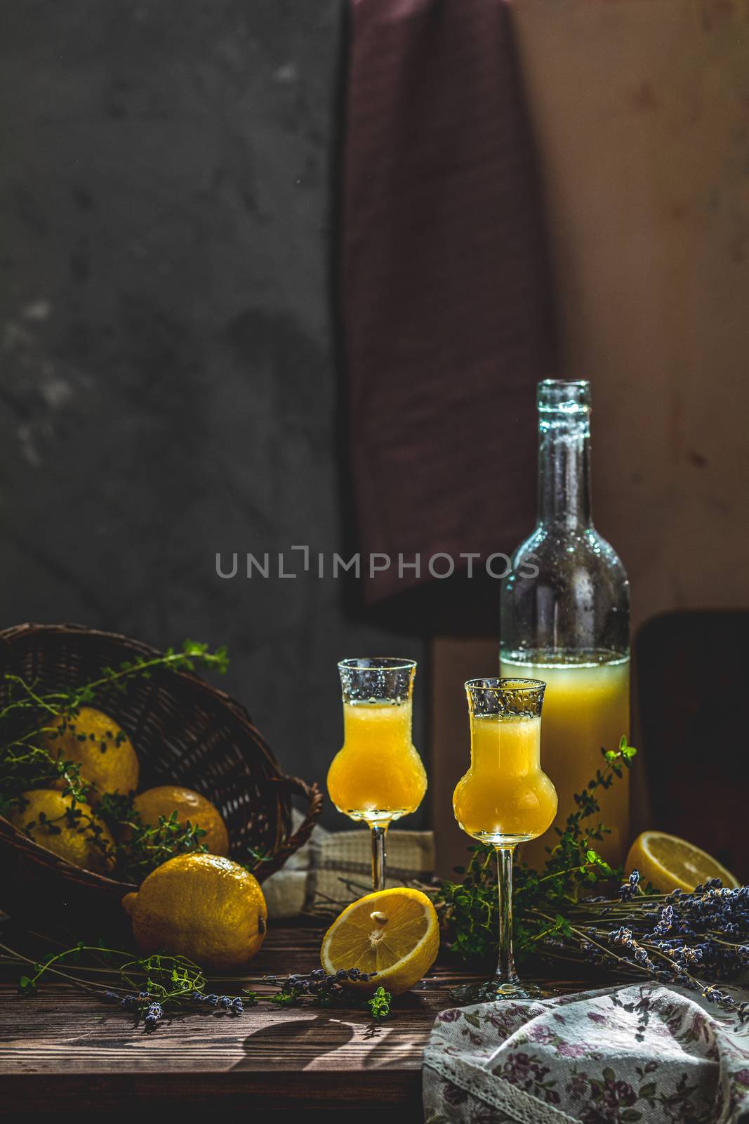 Limoncello in grappas wineglass with water drops and lavender. A by ArtSvitlyna