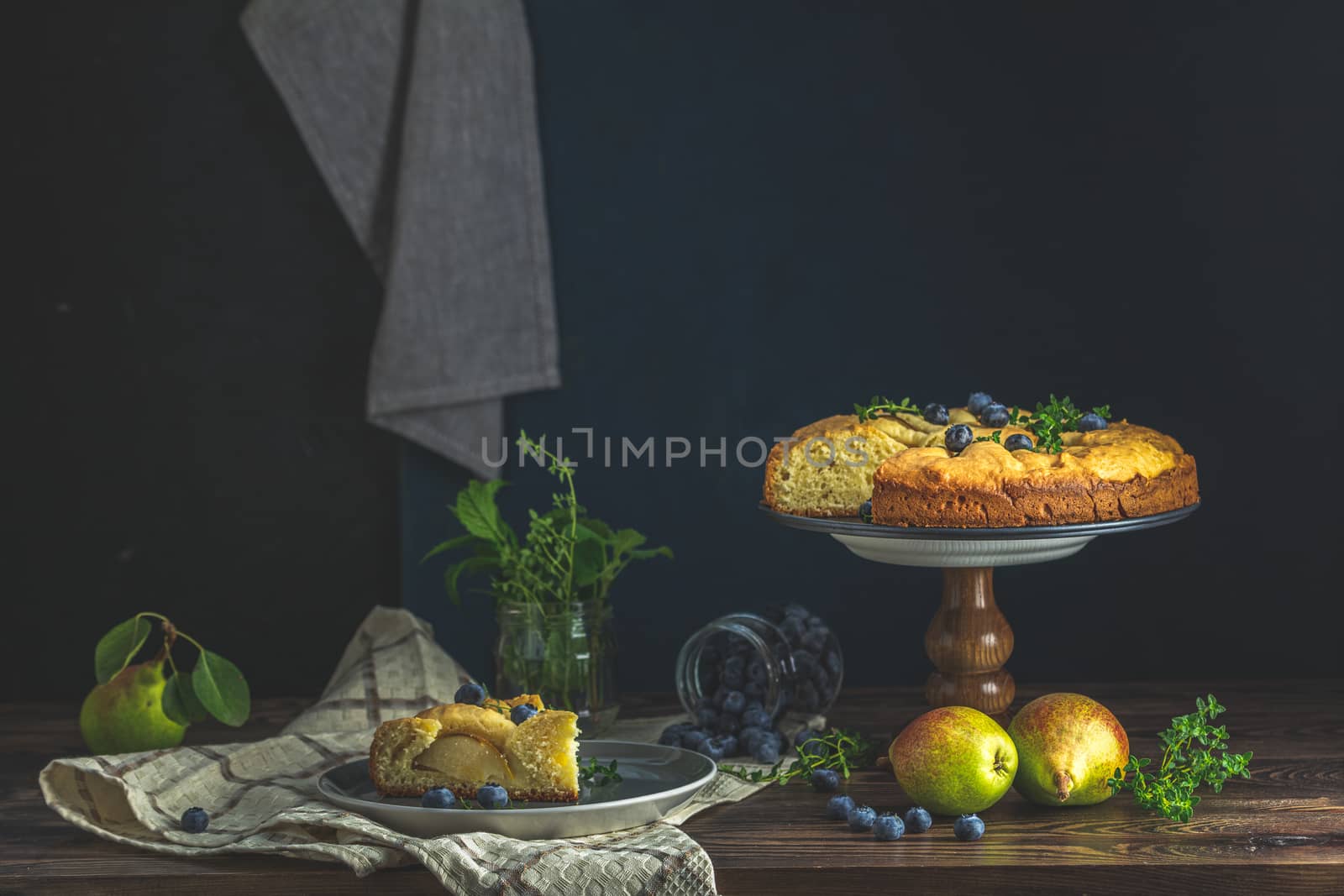 Delicious dessert blueberry tart with fresh berries and pears, sweet tasty cheesecake, berry pie. French cuisine Artistic Still Life in the style of Dutch painting. Copy space for you text
