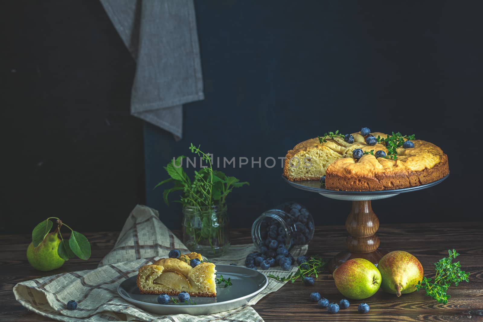 Delicious dessert blueberry tart with fresh berries and pears, sweet tasty cheesecake, berry pie. French cuisine Artistic Still Life in the style of Dutch painting. Copy space for you text