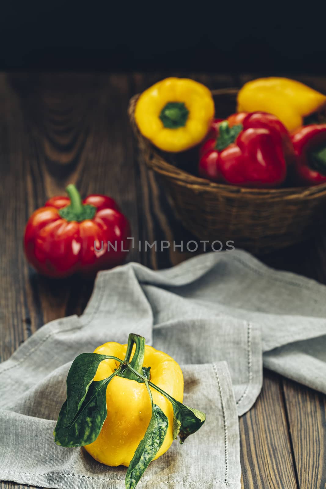 Ripe organic fresh sweet red and yellow pepper on dark wooden table. Selection of healthy food for heart, life concept