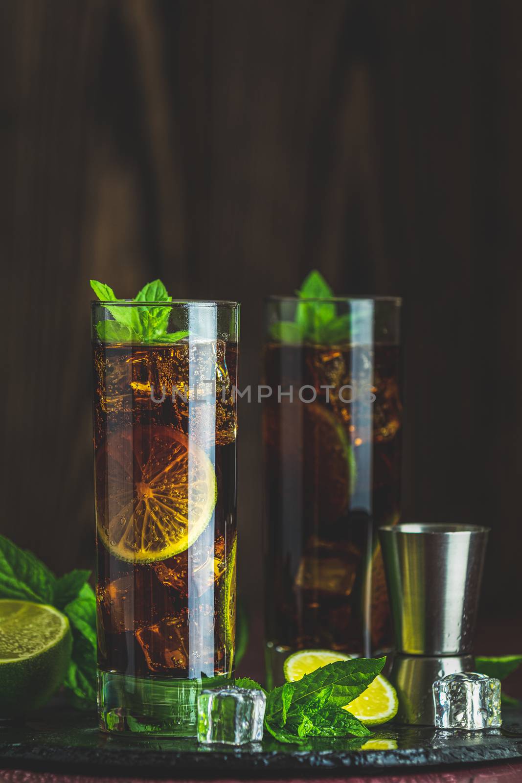 Cold Longdrink Cuba Libre with brown rum and fresh lime by ArtSvitlyna