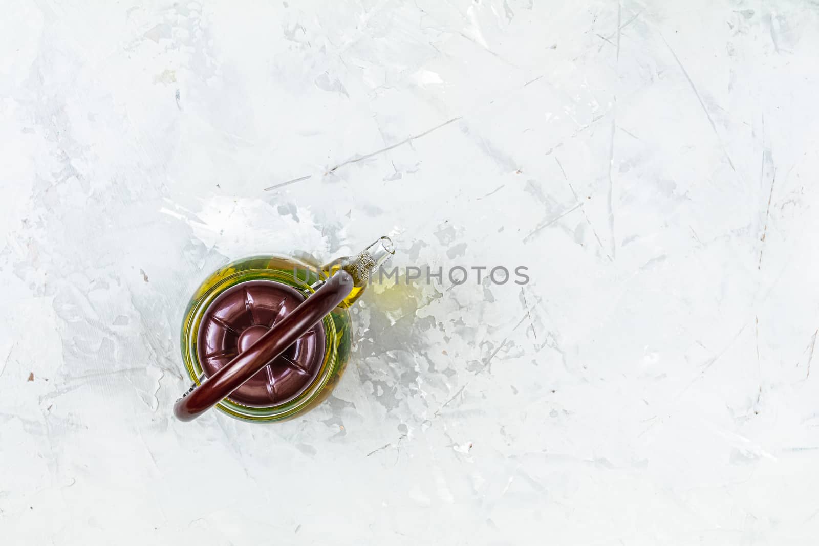 Asian tea set composition. Healthy life and relaxation concept. Glass tea pot on light gray concrete table background. Top view, copy space for you text.