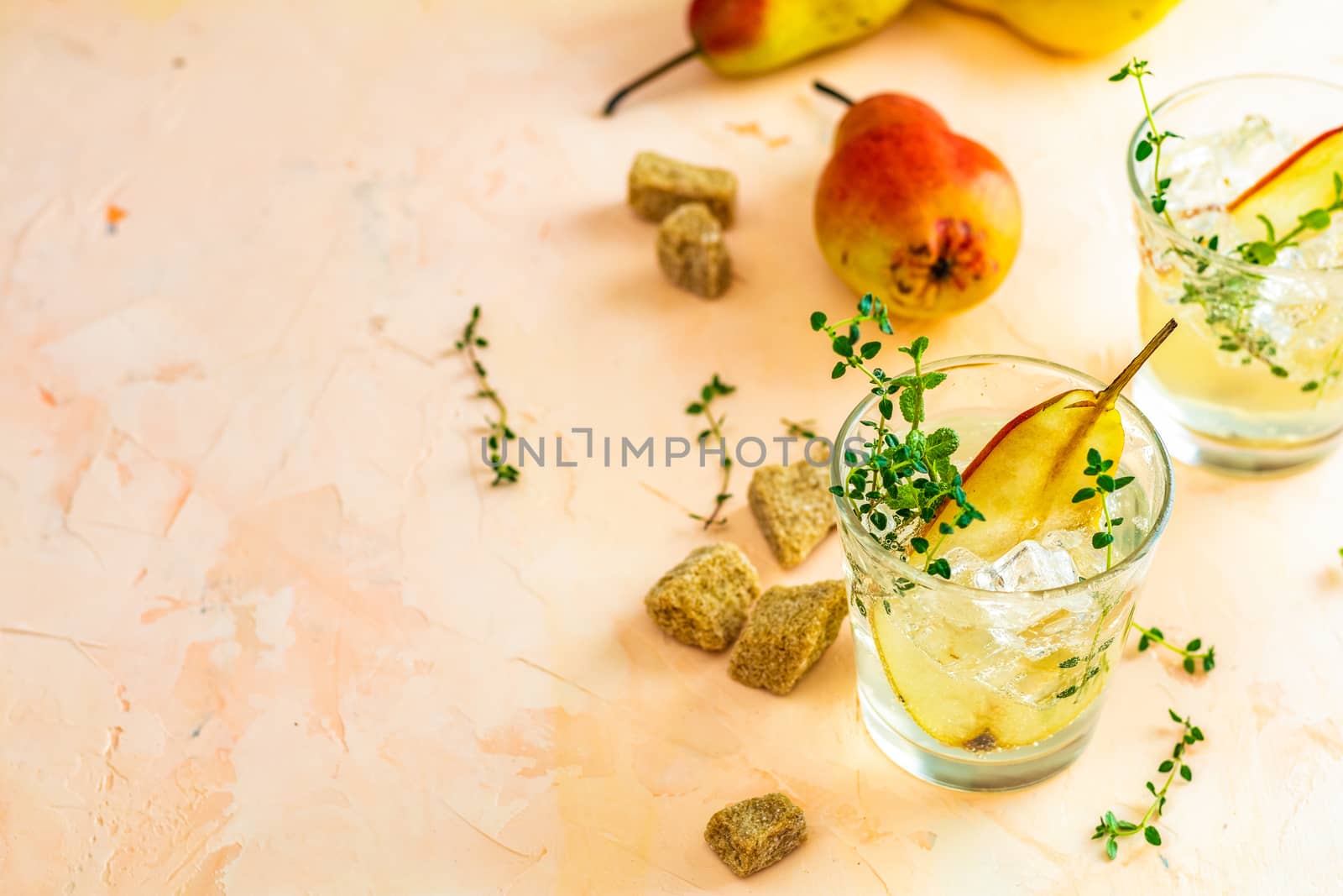 Cold pear white tea with thyme on the wooden background. Summer drinks, thyme pear cocktails. Selective focus, space for text