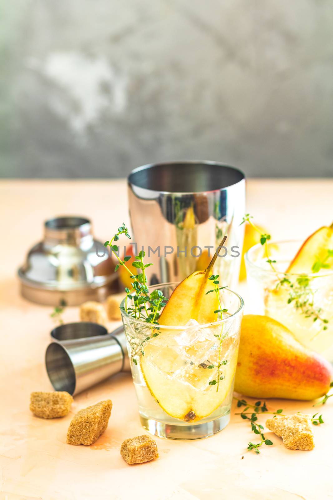 Pear mulled cider with thyme, brown sugar and ice  on light concrete surface table