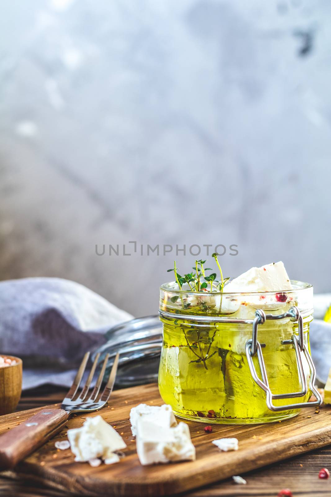 Feta cheese marinated in olive oil in glass jar by ArtSvitlyna