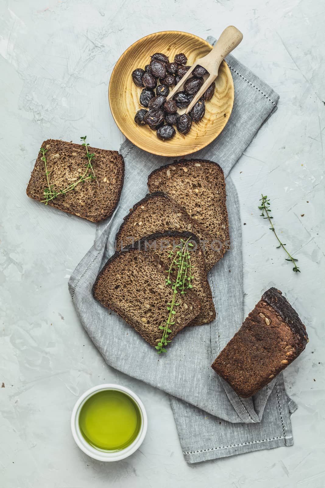 Whole wheat bread baked at home and dried olives by ArtSvitlyna