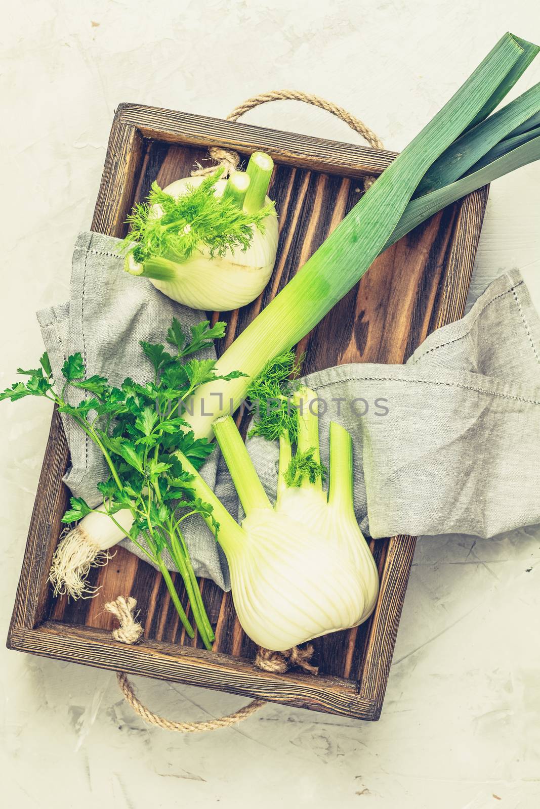 Fennel bulb, leek and parsley in wooden box by ArtSvitlyna