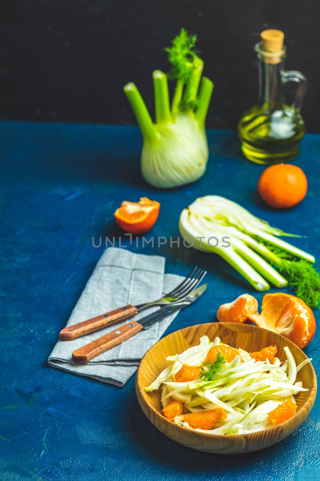 Fennel and orange citrus salad on wooden plate between ingredien by ArtSvitlyna