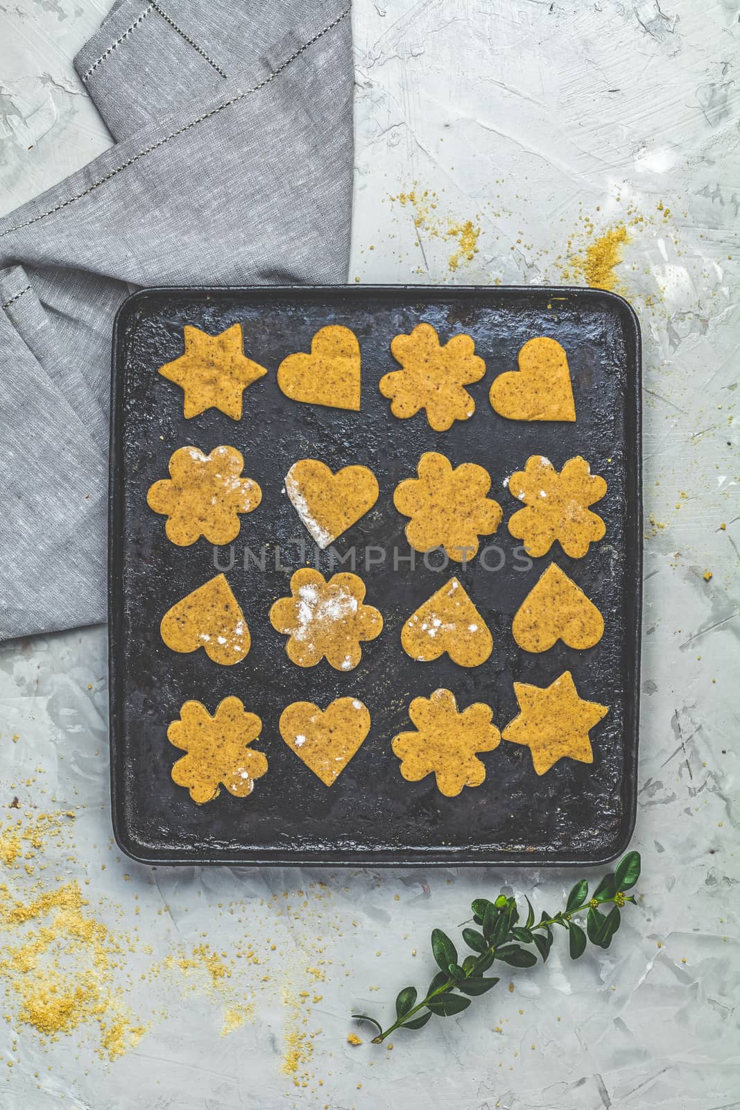 Raw ginger cookies in baking dish on light gray concrete surface by ArtSvitlyna
