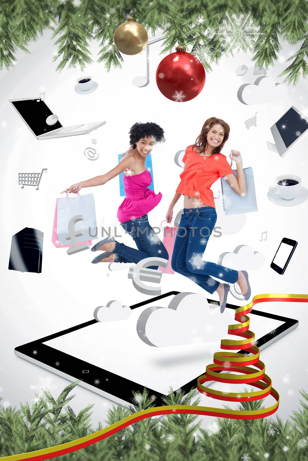 Two smiling women jumping on a tablet pc  against snow falling