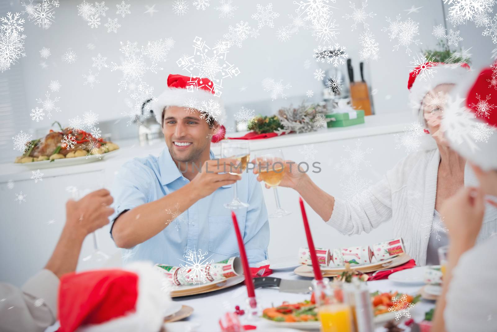 Happy family clinking their glasses of white wine against snowflakes