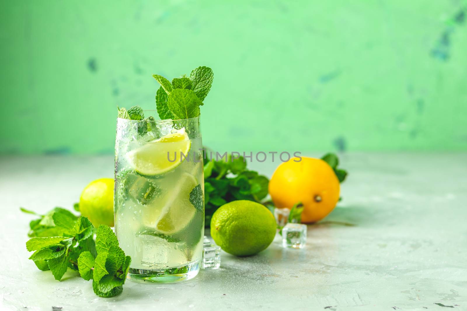 Mojito cocktail with lime and mint in highball glass by ArtSvitlyna