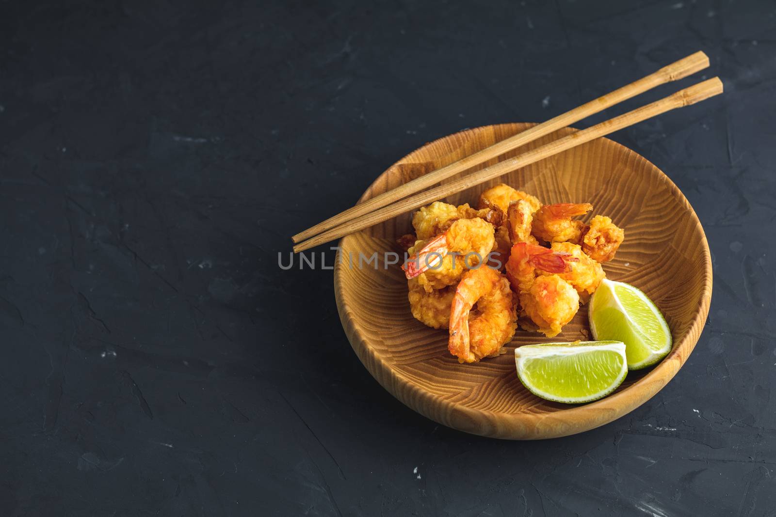 Fried Shrimps tempura with lime in wooden plate  by ArtSvitlyna