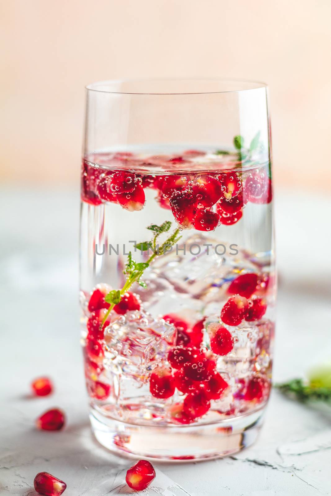 Gin and tonic pomegranate cocktail or detox water with ice by ArtSvitlyna