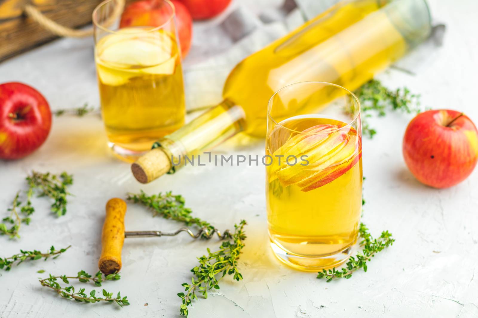 Bottle and glasses of homemade organic apple cider by ArtSvitlyna