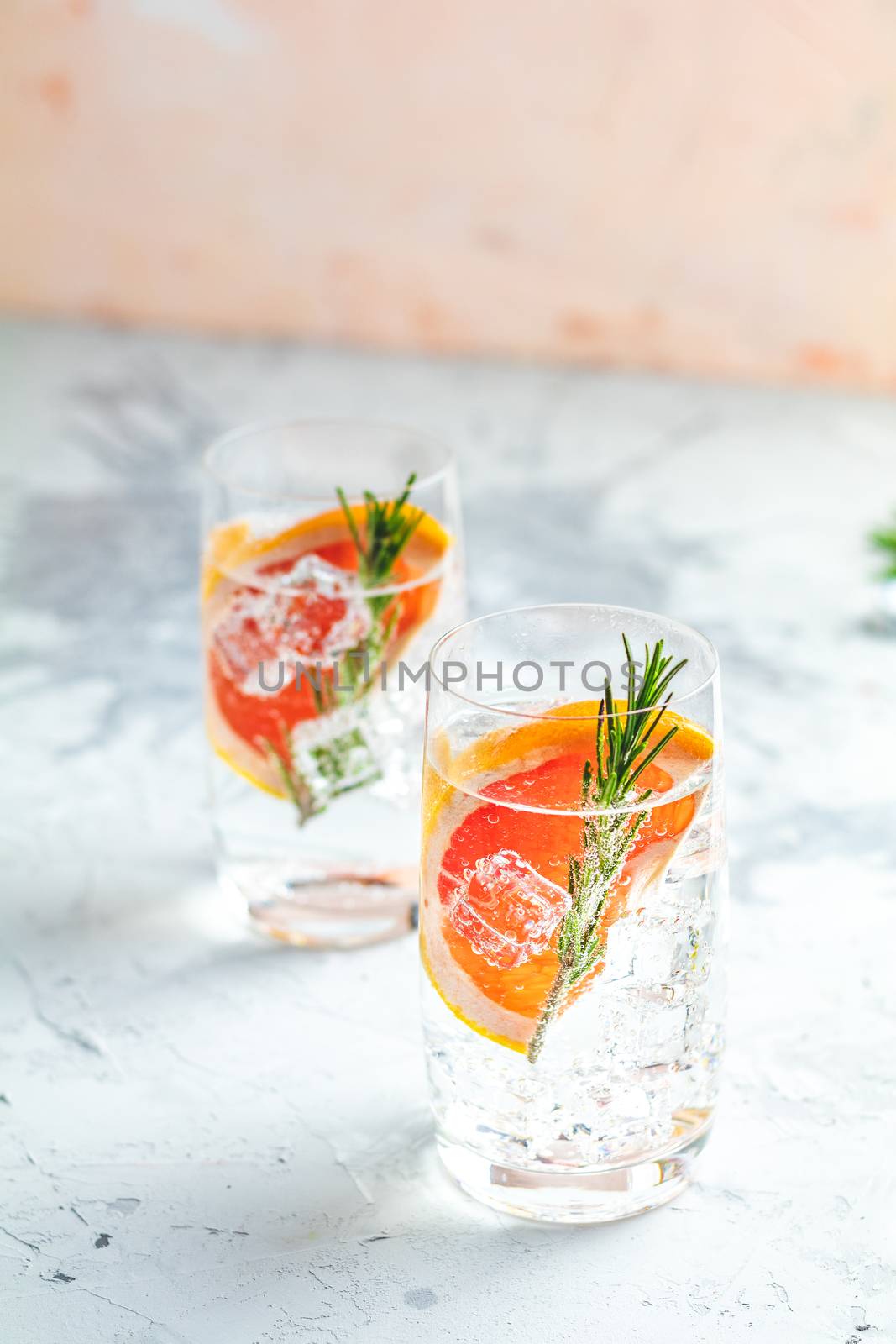 Alcoholic cocktail with grapefruit, soda, ice, gin and rosemary by ArtSvitlyna