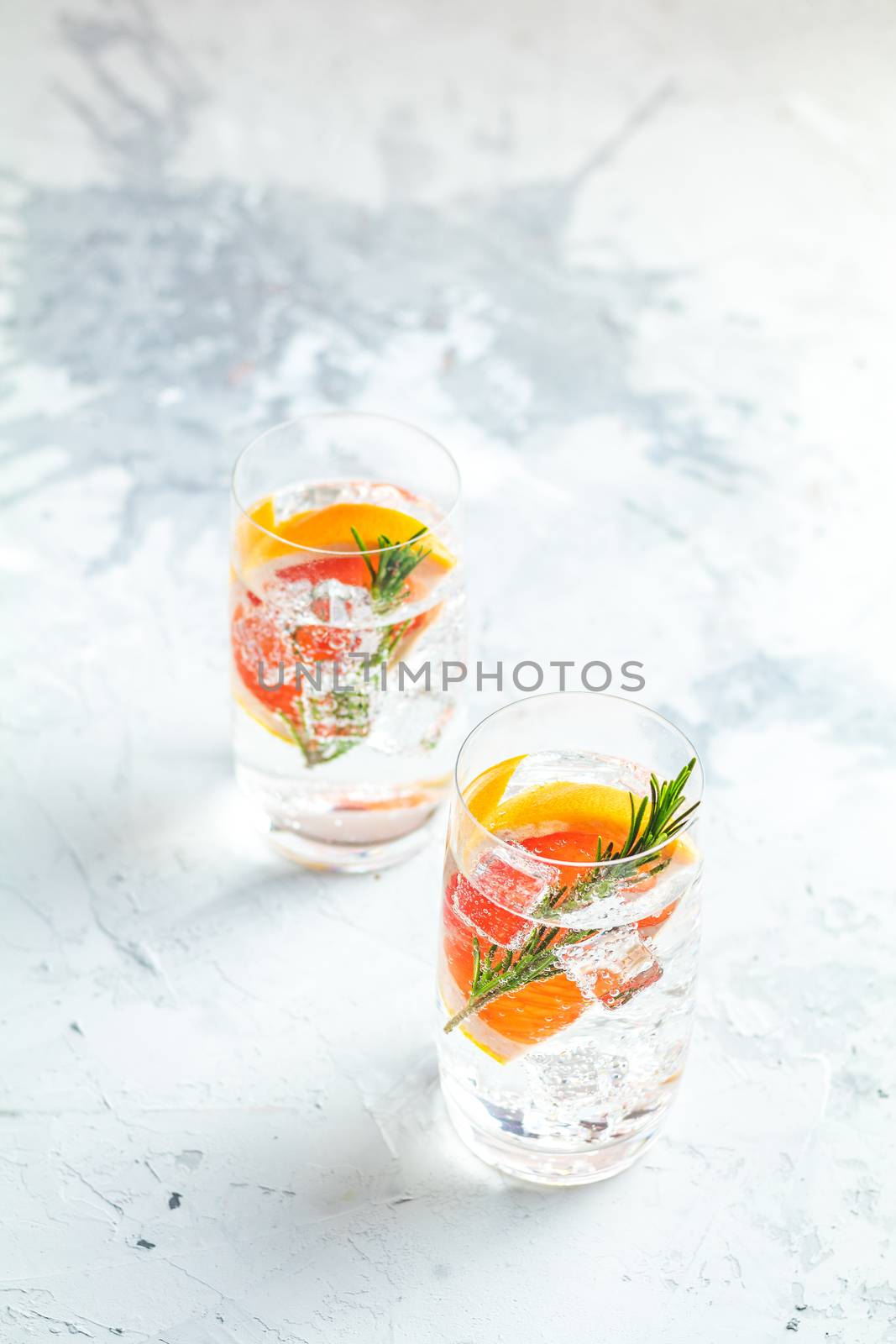 Alcoholic cocktail with grapefruit, soda, ice, gin and rosemary by ArtSvitlyna