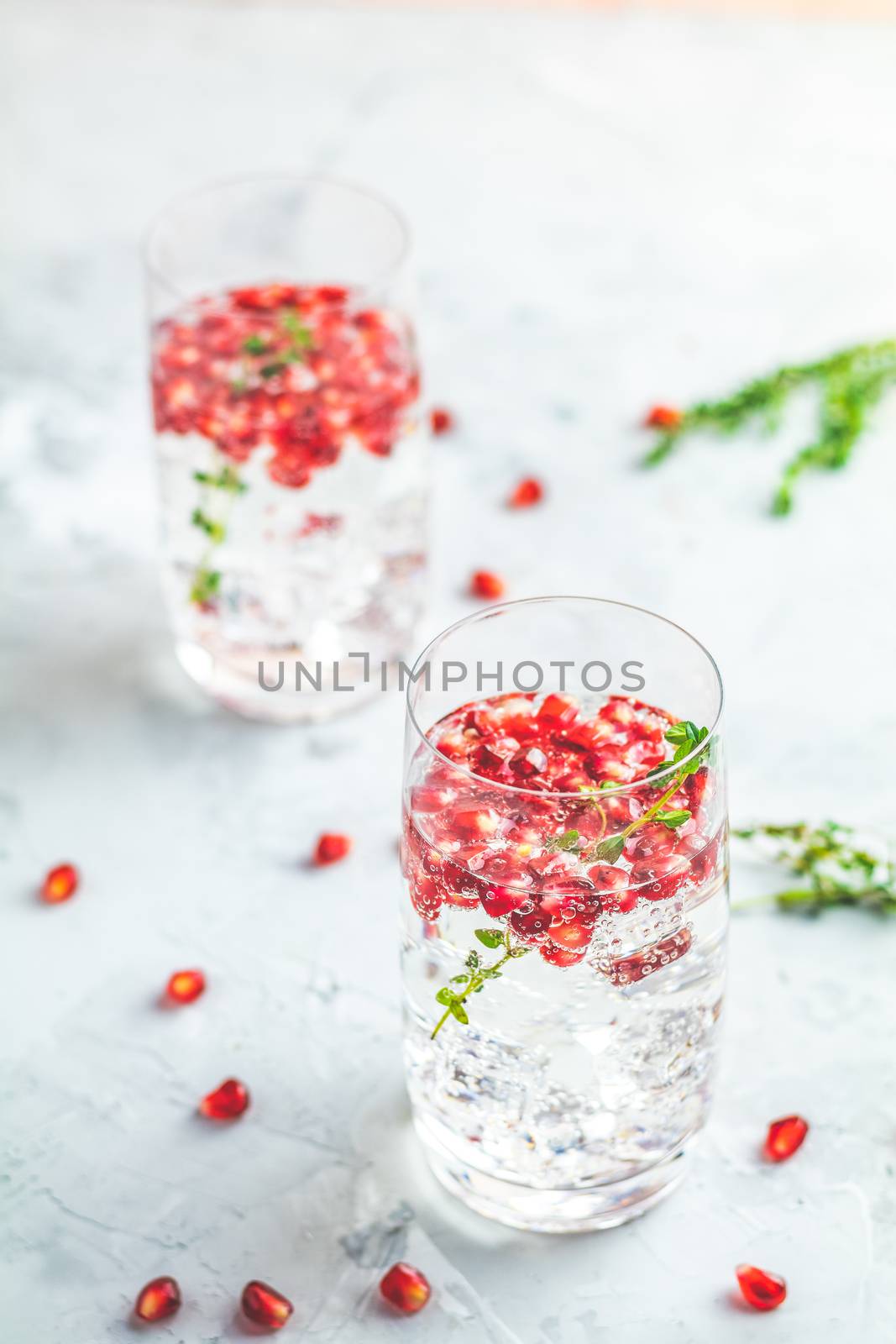 Gin and tonic pomegranate cocktail or detox water with ice by ArtSvitlyna