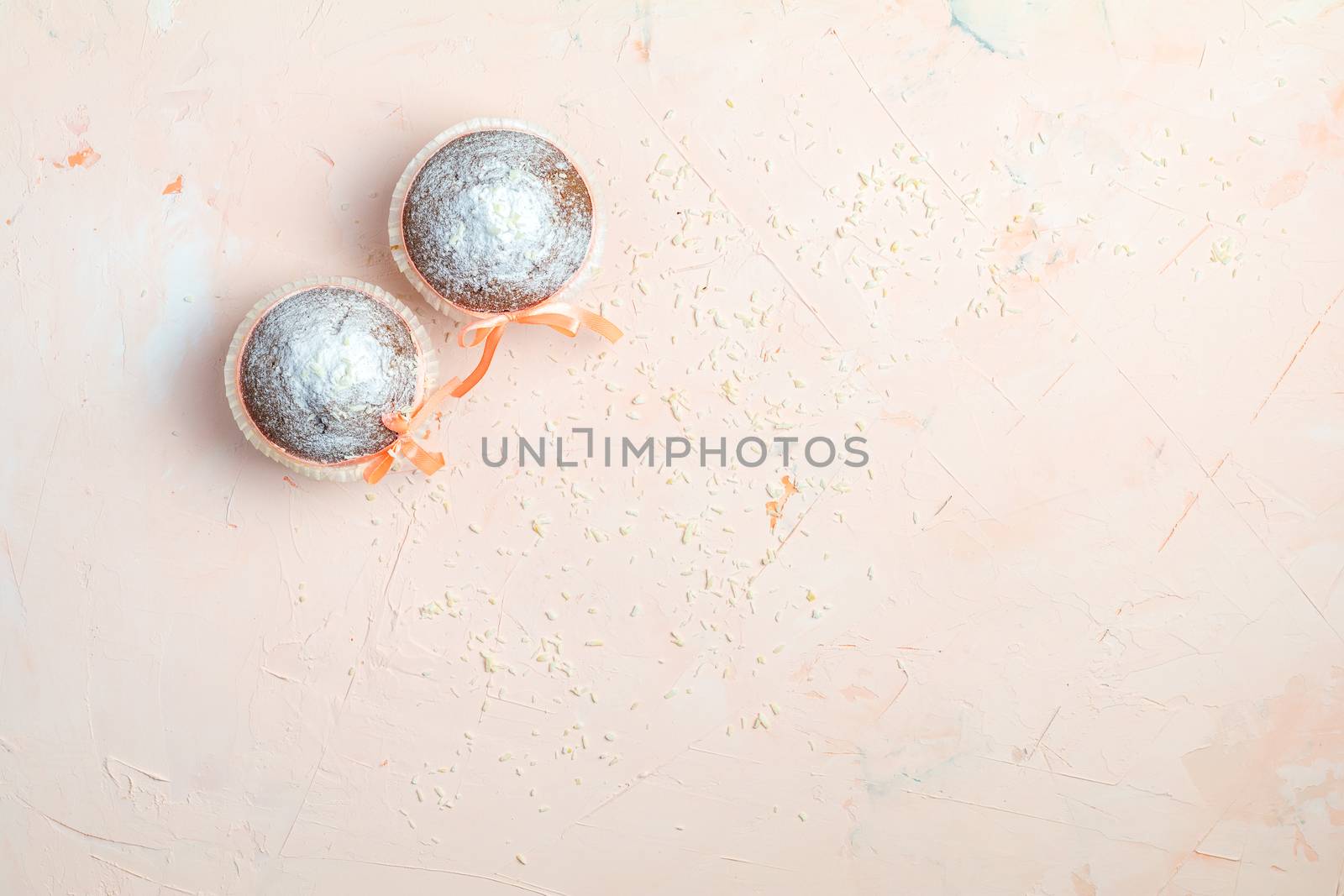 Muffin on light pink living coral stone concrete surface by ArtSvitlyna