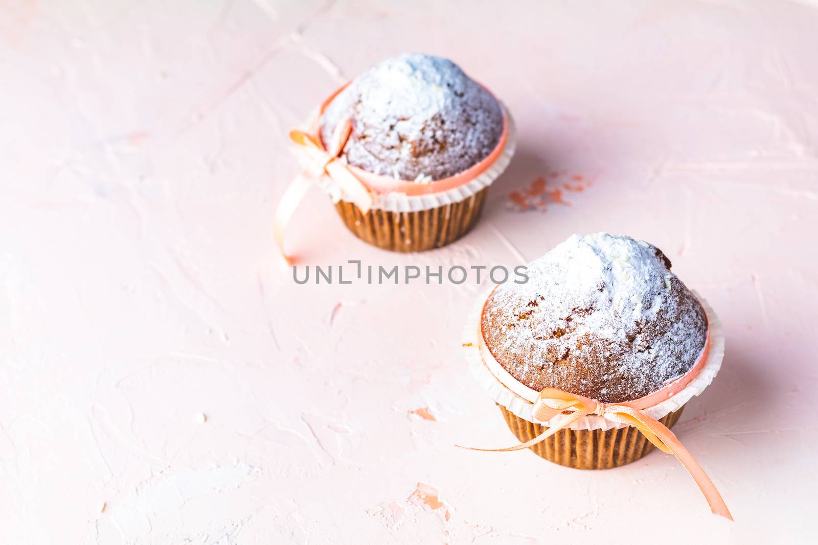 Homemade muffin on light pink living coral stone concrete surfac by ArtSvitlyna