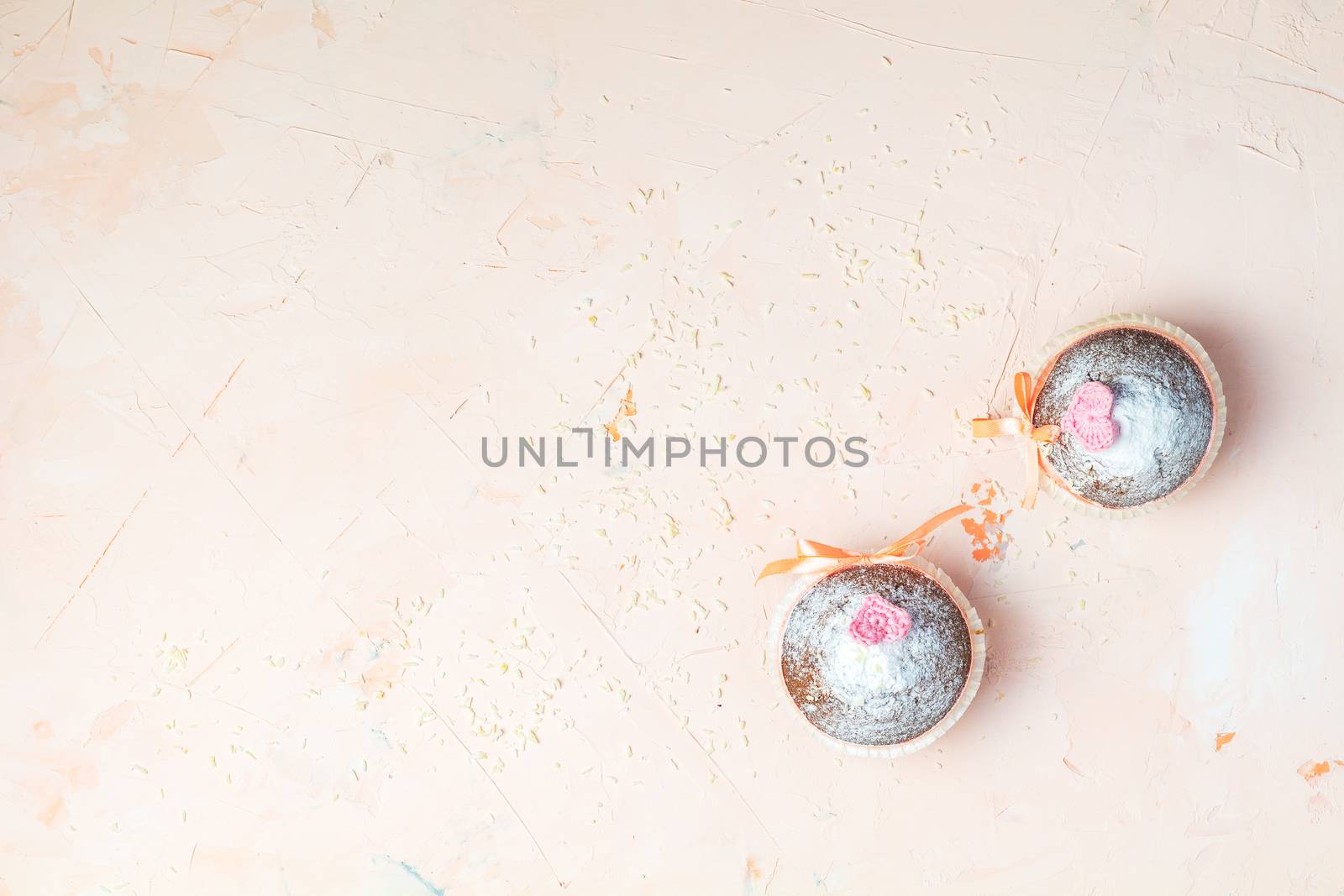 Tasty delicious homemade muffin on light pink living coral stone concrete surface, top view, copy space. Beautiful food concept for Valentine day or Wedding, Birthday